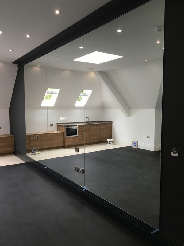 Frameless glass partition in loft conversion by Potters Bar glaziers