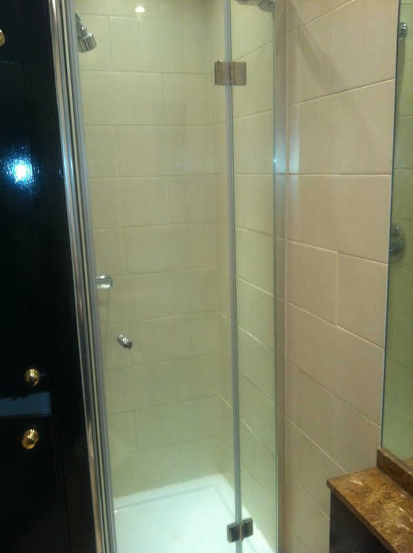 Frameless glass shower enclosure with chrome fittings in Potters Bar
